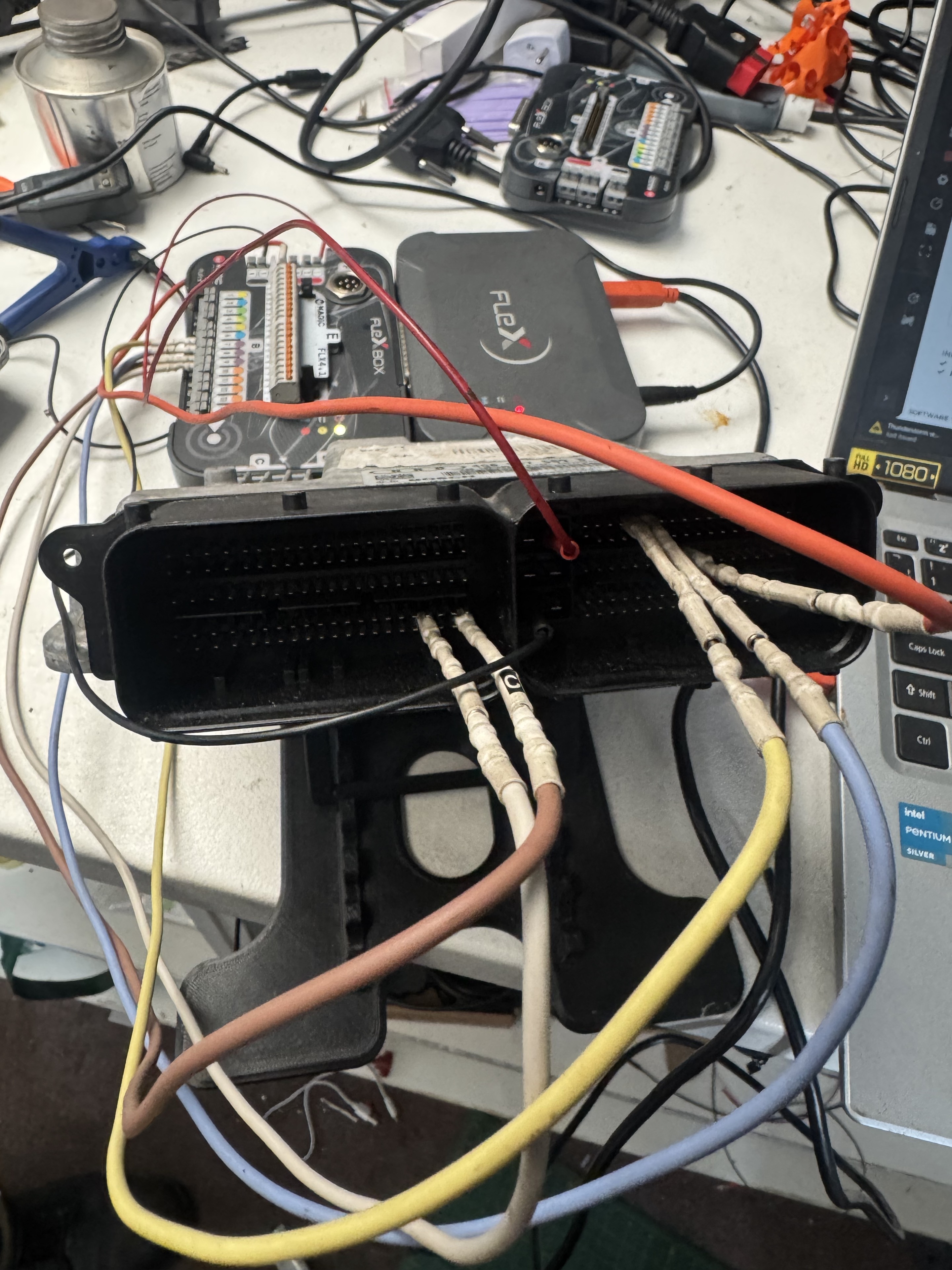 ECU connected to bench programming tools for remapping at Prestige Performance Group
